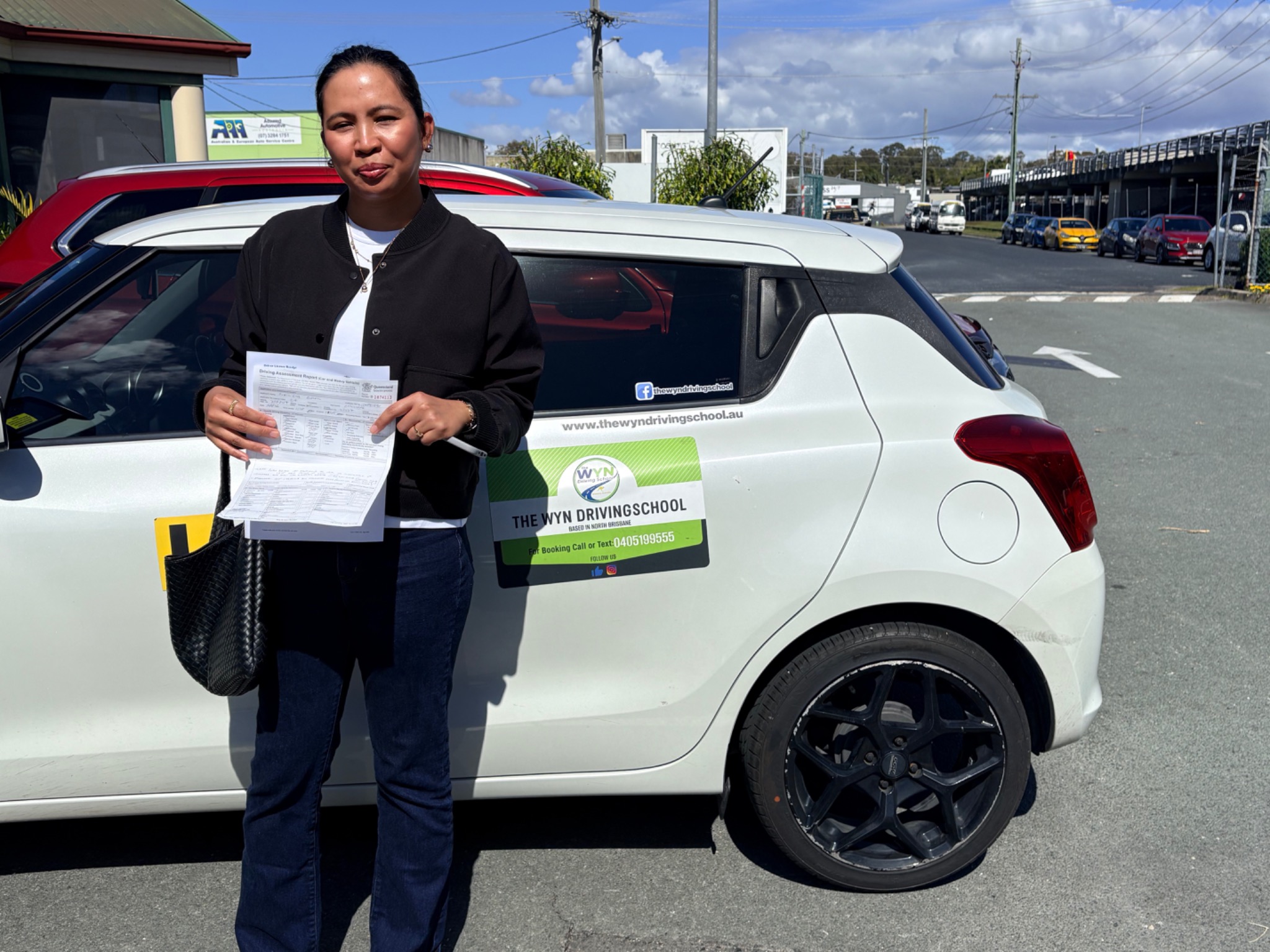 Mimi celebrating after passing her practical driving test on the first attempt at Strathpine
